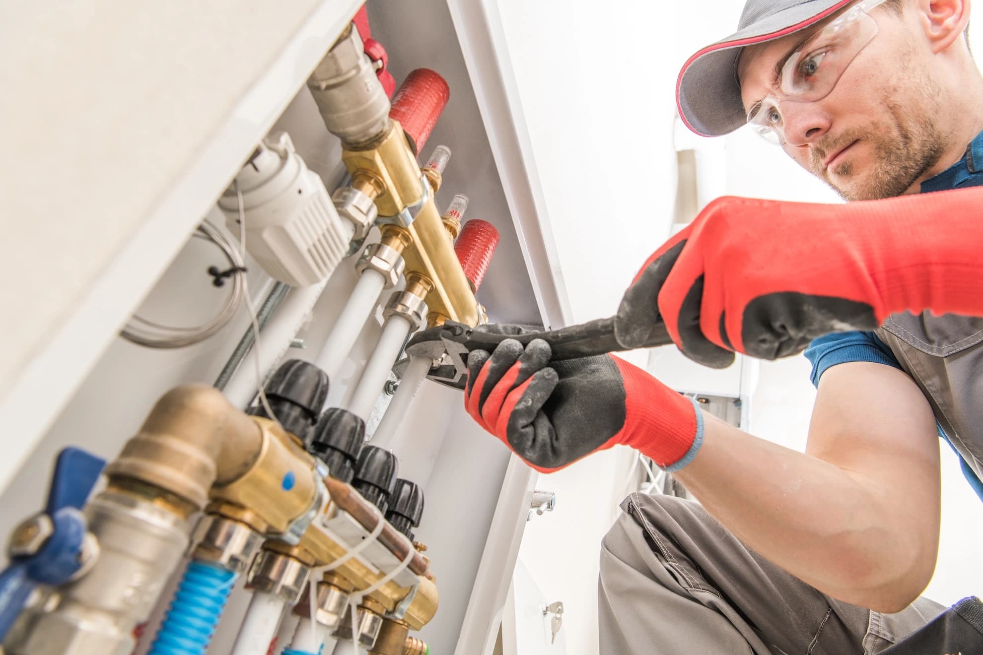 Plumber repairing pipes with a wrench